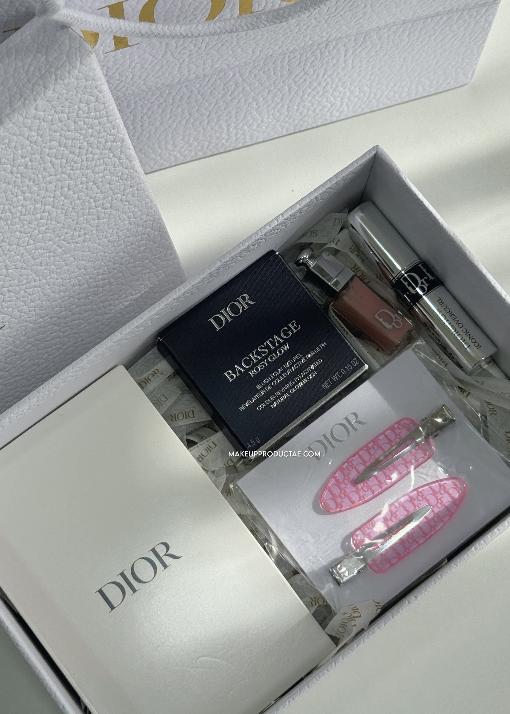 Dior cosmetic set with lip products and accessories in a branded box.
