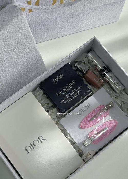 Dior cosmetic set with lip products and accessories in a branded box.