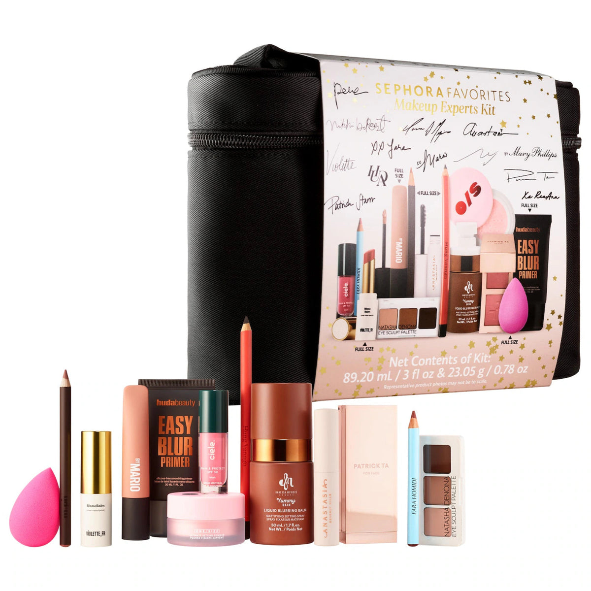 Sephora Makeup Favorites Kit containing multiple cosmetic products arranged in front of a black zippered carrying case with a printed product card. Visible items include a pink makeup sponge, brown pencil, gold-capped cream bottle, pink cream jar, brown powder compact, dual-color eyeshadow palette, and other makeup items on a white background.